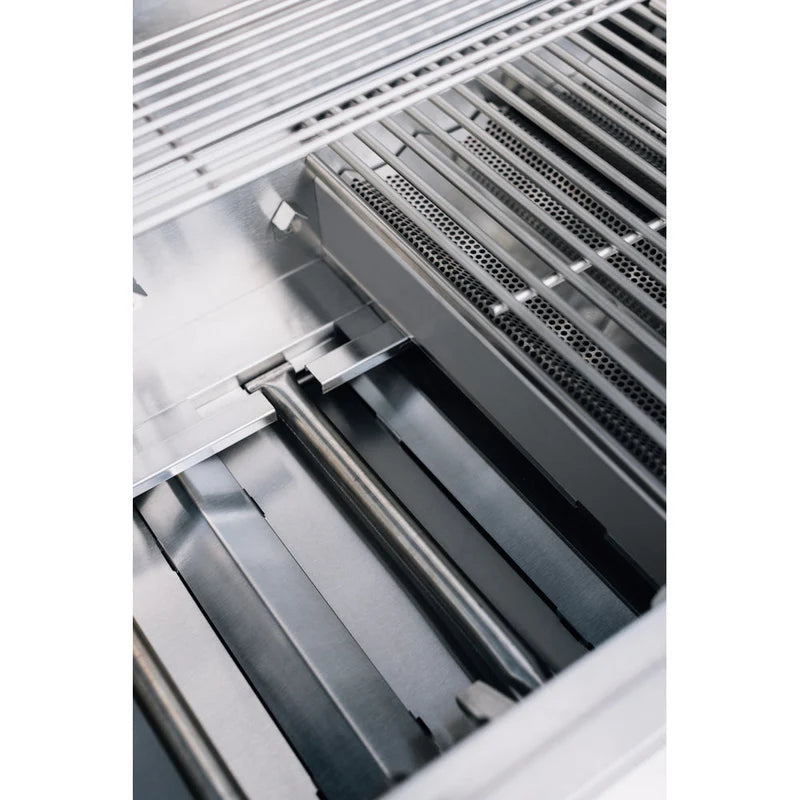 Built-in gas grill interior showing warming rack and stainless steel burners by TrueFlame