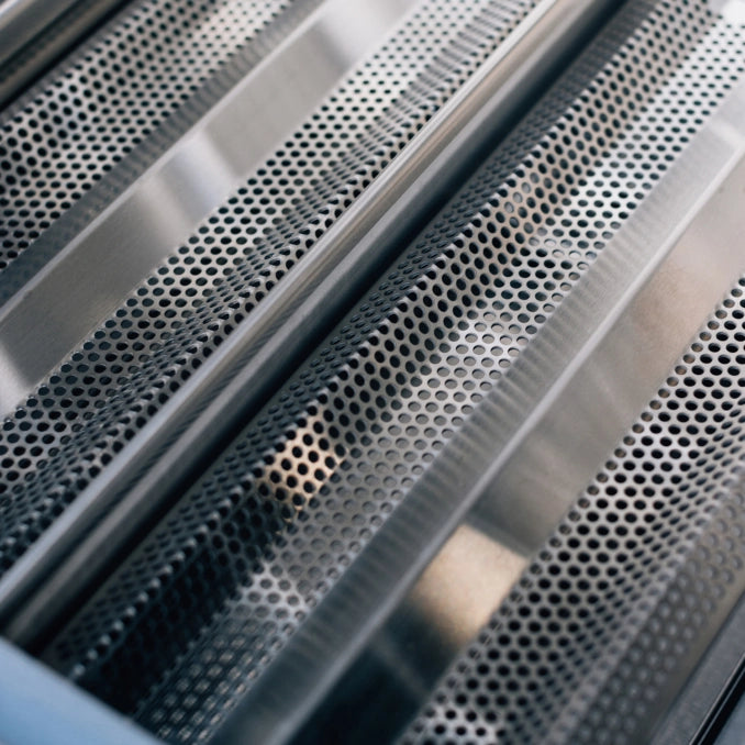 Perforated stainless steel flame tamers on TrueFlame TFE Series gas grill